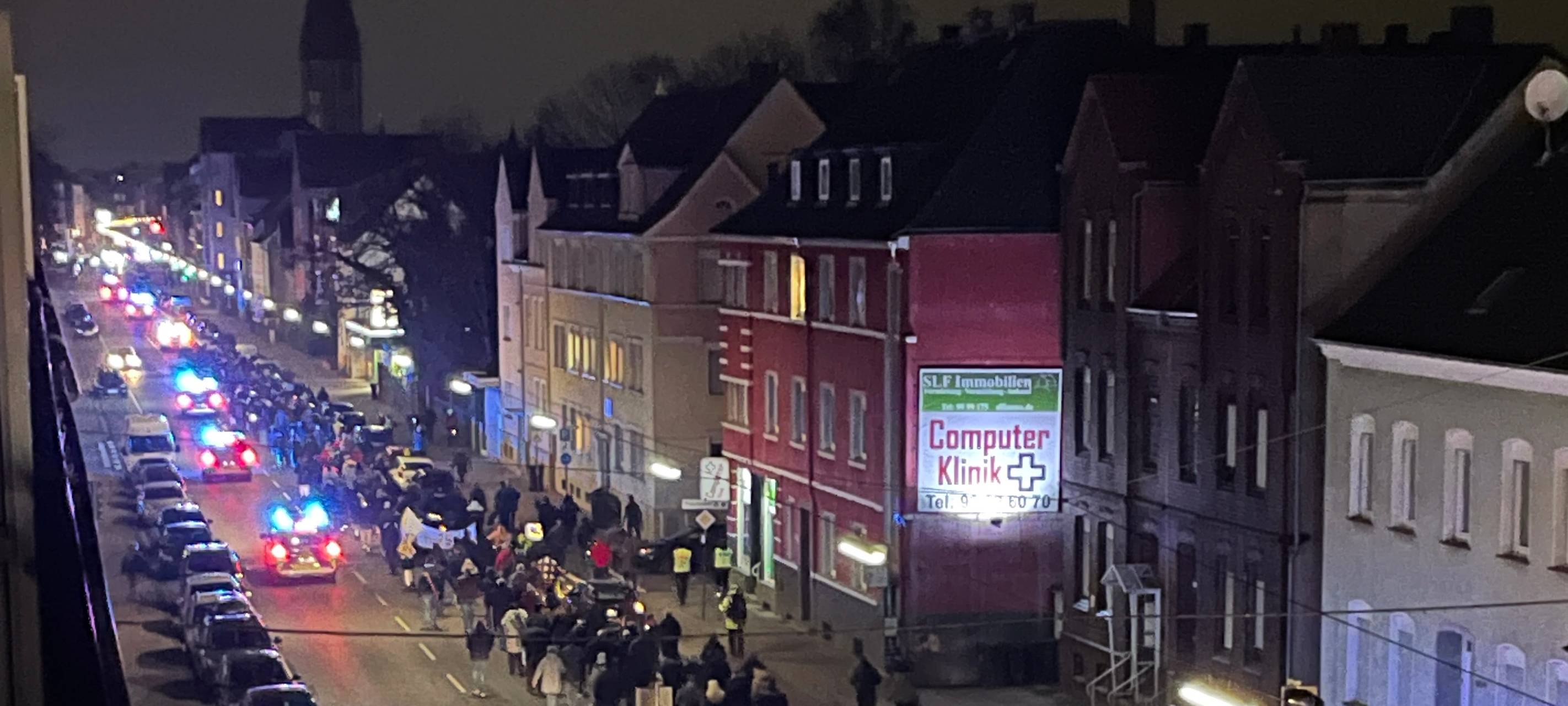 Fast 500 Hammer laufen in einer Demo über die Werler Straße am Abend, begleitet von mehreren Polizeiwagen.